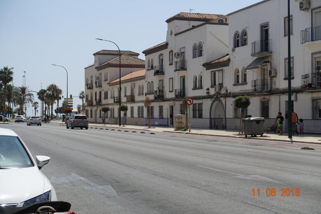 a white car parked on the side of a street with buildings at Princ Gabi in Málaga