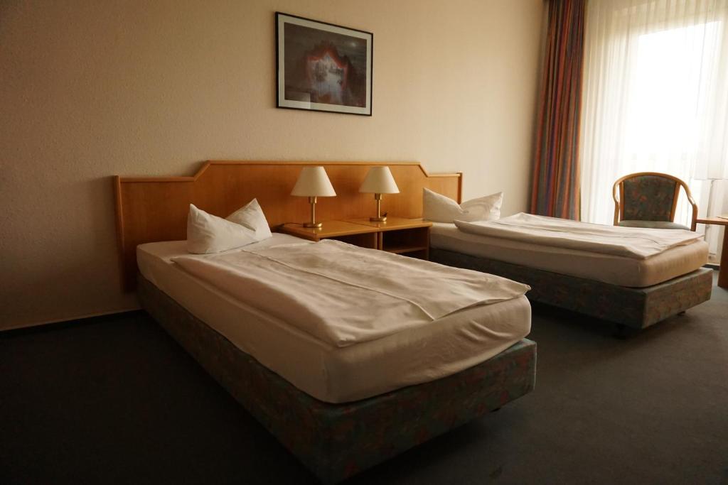 Postel nebo postele na pokoji v ubytování Hanse-Hotel Stendal