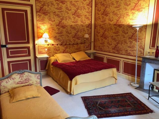 Postel nebo postele na pokoji v ubytování Les chambres d'hôtes du Manoir de Roz-Maria