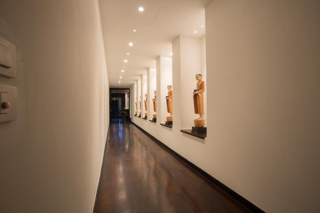 a hallway of a museum with statues on the walls at Villa Princess Stephanie in Kata Beach