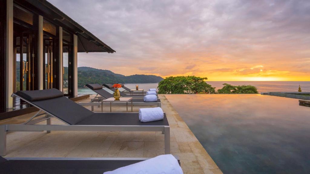 a villa with a view of the ocean at sunset at Villa Princess Stephanie in Kata Beach