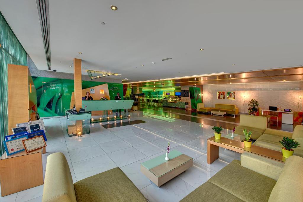 a lobby of a hospital with couches and tables at Al Khoory Executive Hotel, Al Wasl in Dubai