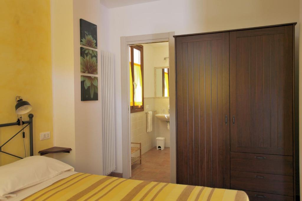 a bedroom with a bed and a door to a bathroom at B&B Ca' De Angiolina in Sanremo