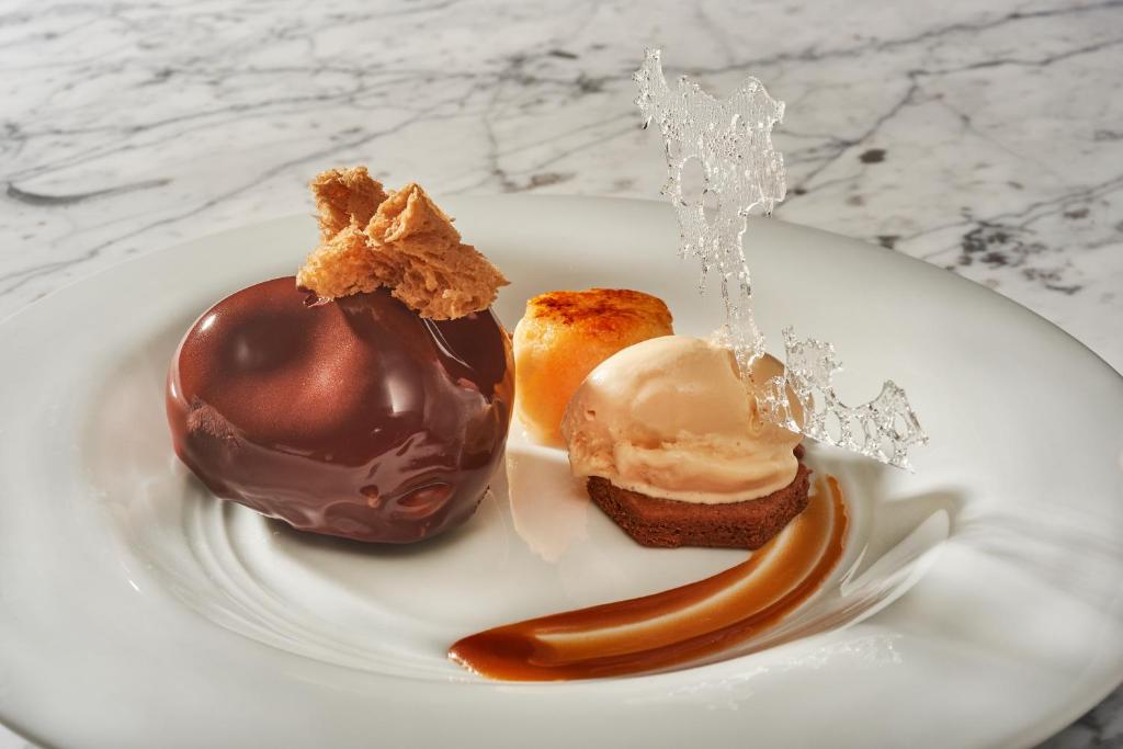 a white plate with two different types of desserts at Cascade Wellness Resort in Lagos