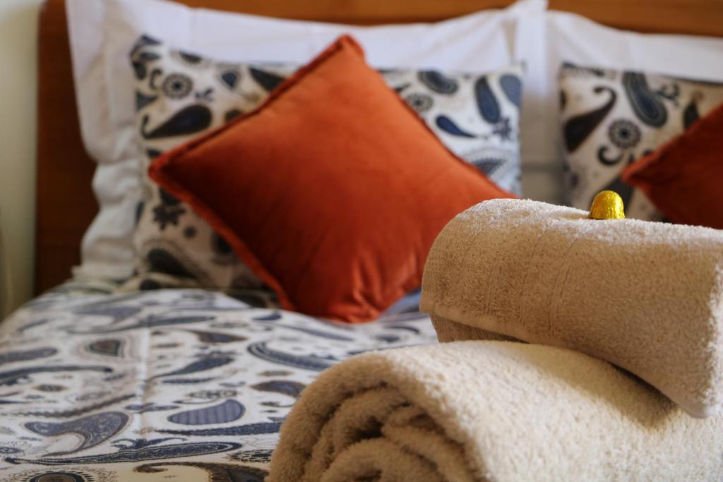 a bed with a towel on it with pillows at Jardim das Amoreiras Central Apartment in Lisbon