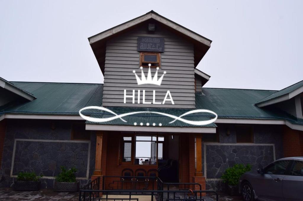a building with a sign that reads hilla at Hilla Apartments Nathia Gali in Abbottābād