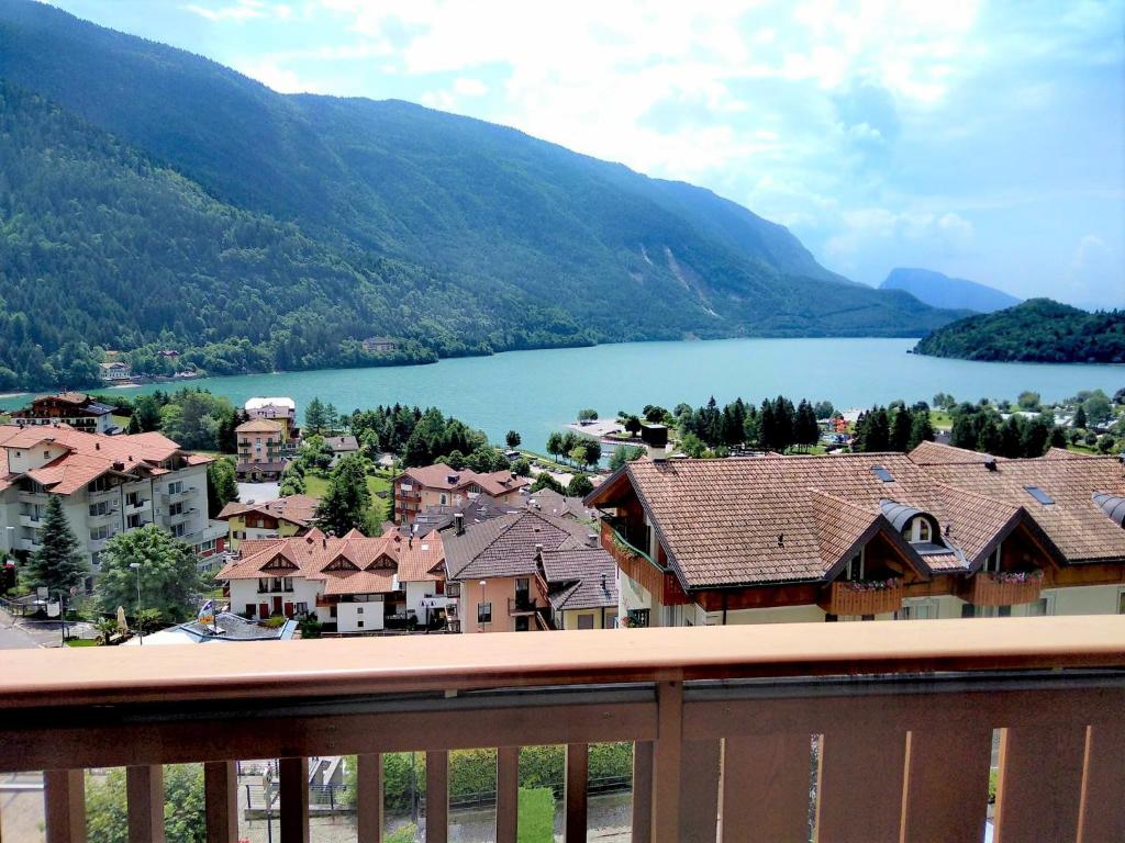 a view of a town and a lake from a balcony at Hotel Panorama in Molveno