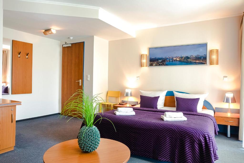 Postel nebo postele na pokoji v ubytování Hotel Ambiente Berlin City