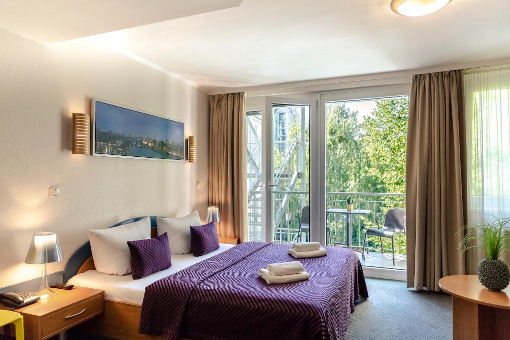 Postel nebo postele na pokoji v ubytování Hotel Ambiente Berlin City