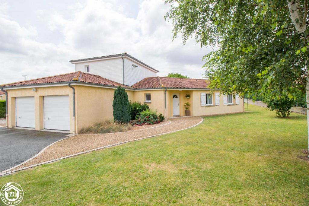 a house with a driveway in front of it at Gite de la plaine in Saint-Ignat