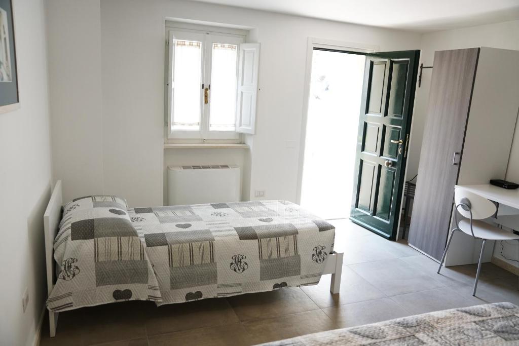 Postel nebo postele na pokoji v ubytování Rizzi Residence