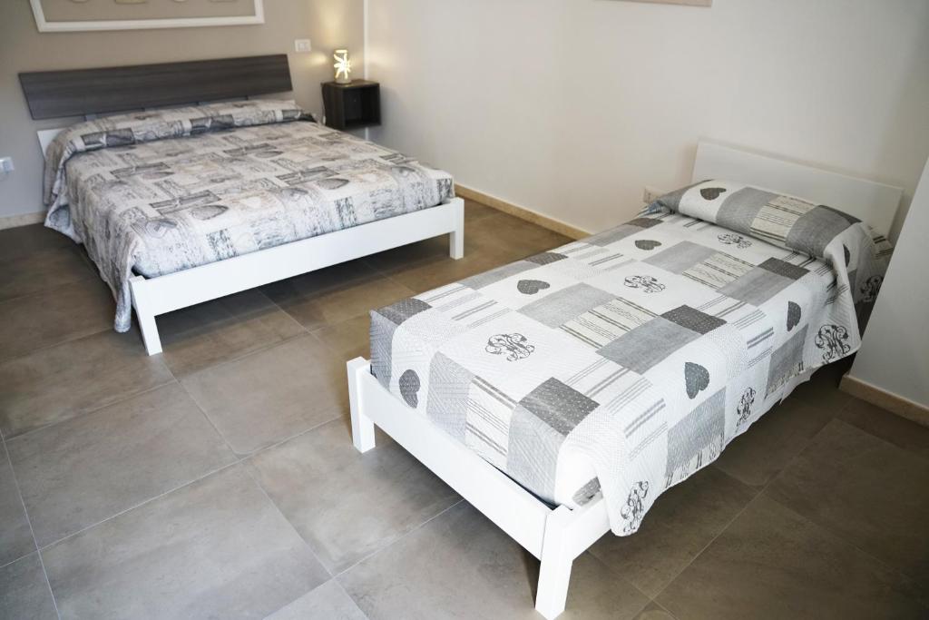 Postel nebo postele na pokoji v ubytování Rizzi Residence