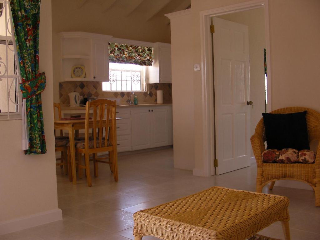 a kitchen and dining room with a table and chairs at Plover Court Apartments in Christ Church