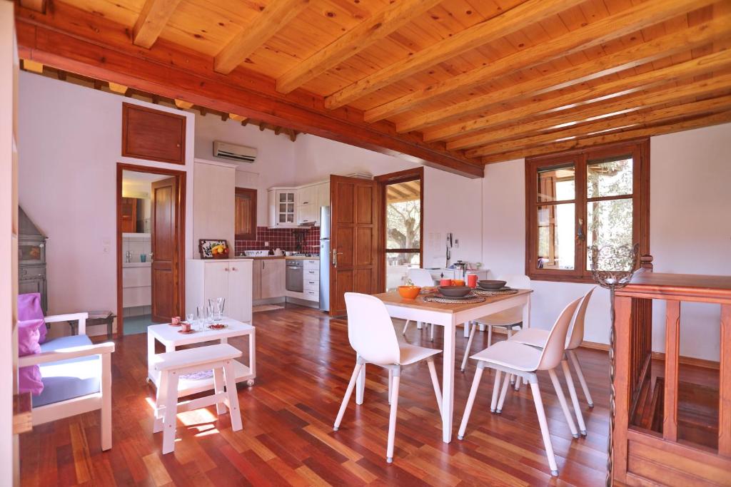a kitchen and dining room with a table and chairs at Cambos Villa in Skopelos Town