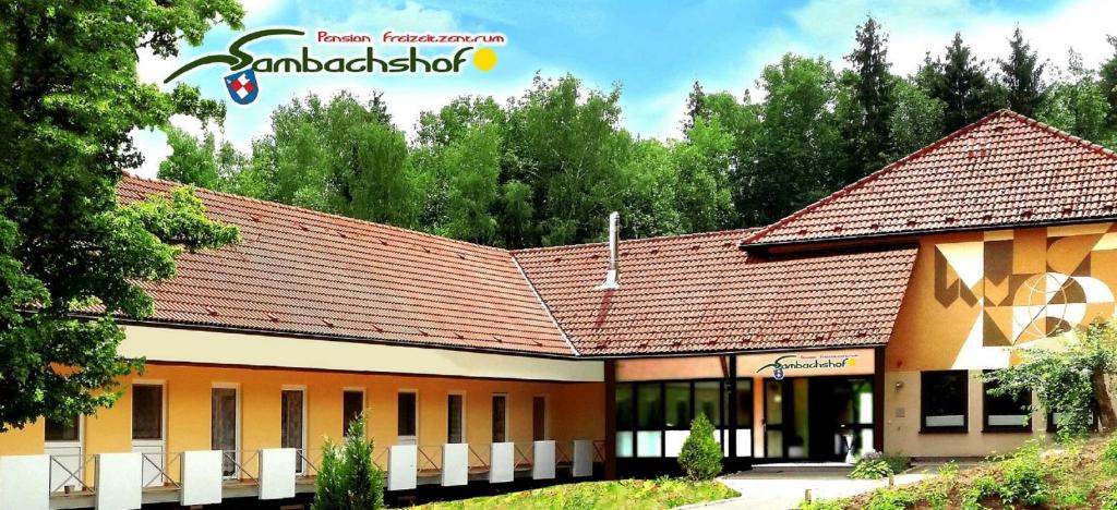 a school building with a brown roof at Pension Freizeitzentrum Sambachshof in Bad Königshofen im Grabfeld