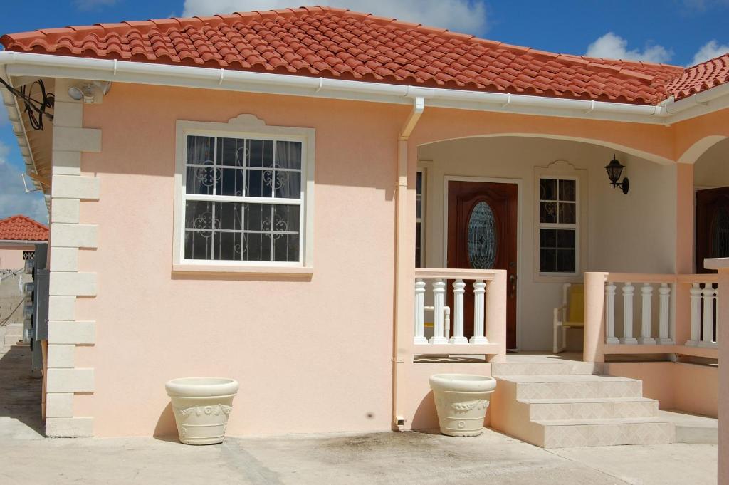 a house with a toilet in front of it at Plover Court Apartments in Christ Church