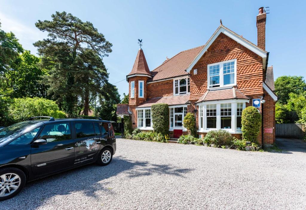 a car parked in front of a house at The Lawn Guest House Gatwick in Horley