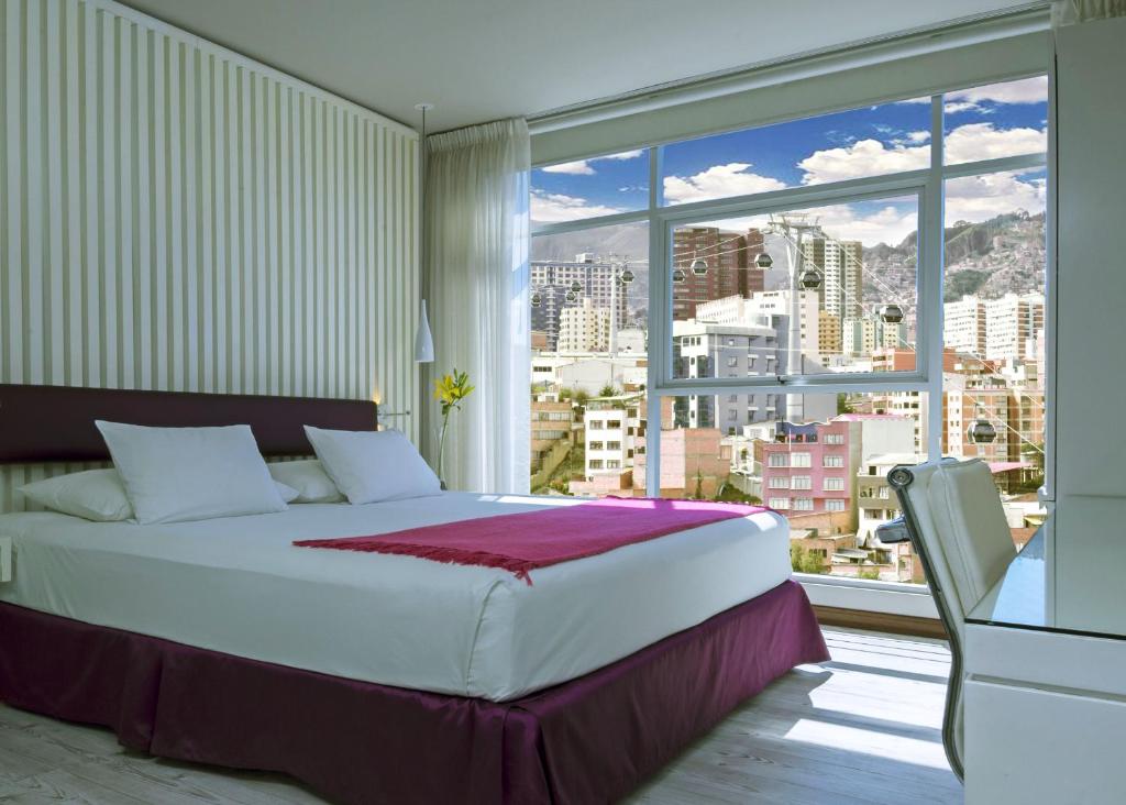 
a hotel room with a bed and a window at Stannum Boutique Hotel & Spa in La Paz
