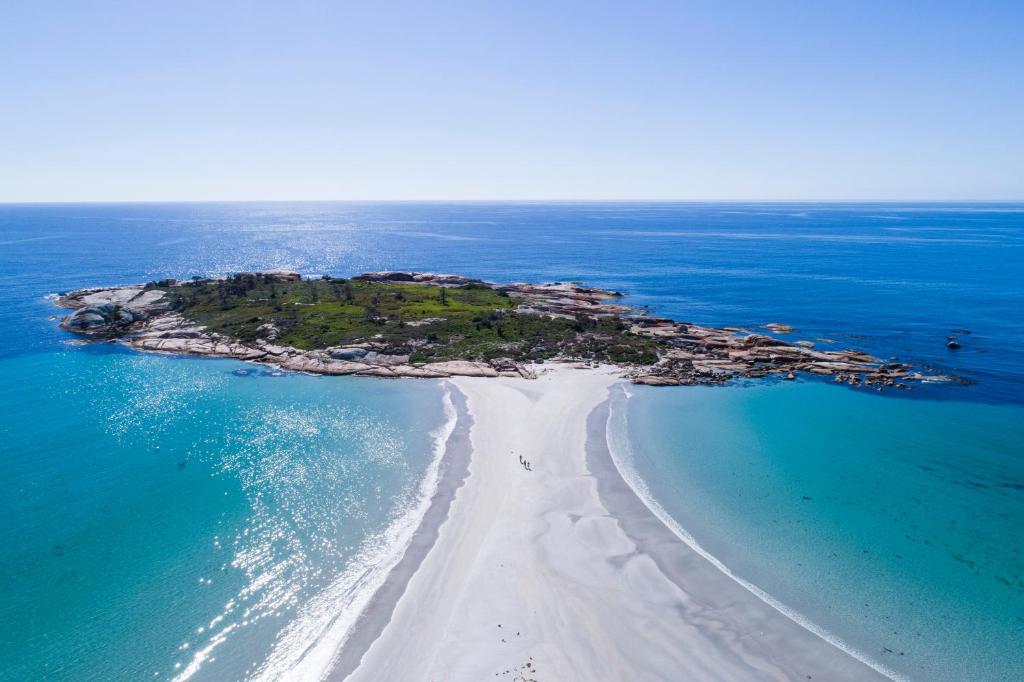 an aerial view of an island in the ocean at Diamond Island Resort & Bicheno Penguin Show in Bicheno