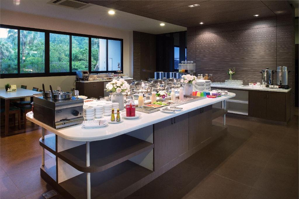 a large kitchen with a table with food on it at Simplitel in Karon Beach