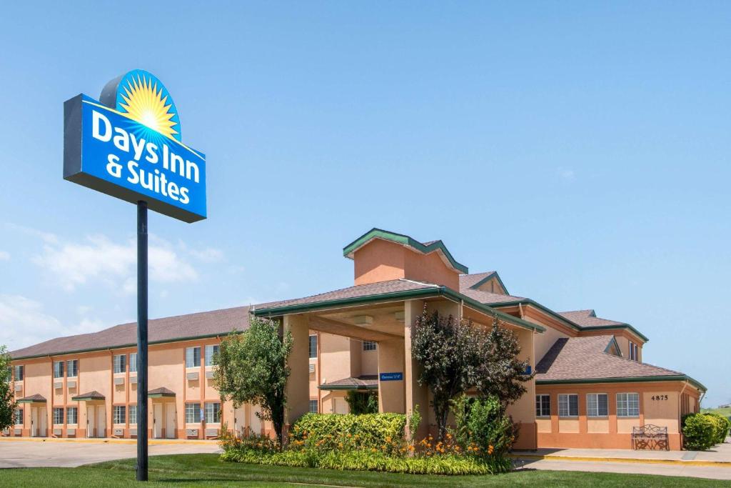 a sign in front of a building at Days Inn & Suites by Wyndham Wichita in Wichita