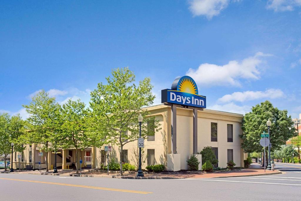 a large building with a sign on the side of it at Days Inn by Wyndham Silver Spring in Silver Spring