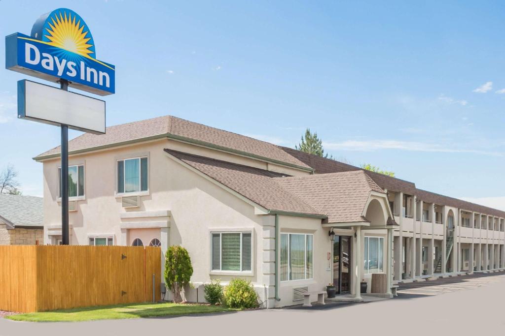 a rendering of a days inn sign in front of a building at Days Inn by Wyndham Kimball in Kimball