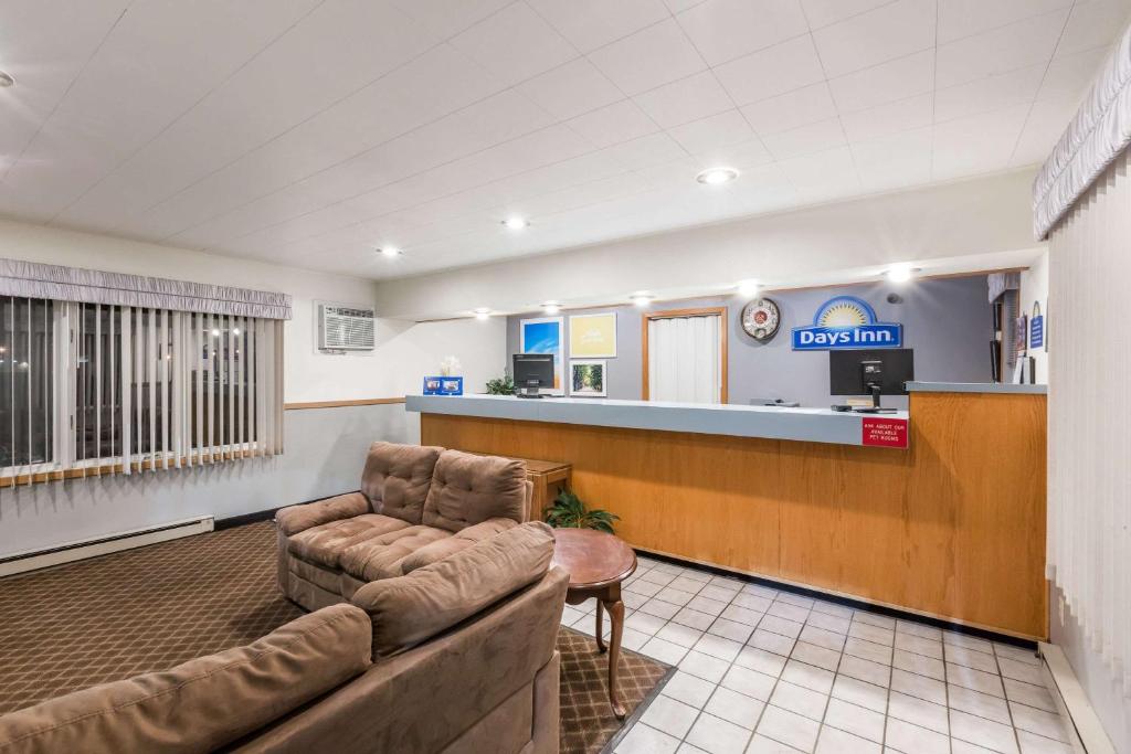 a waiting room at a hospital with a couch and a counter at Days Inn by Wyndham Atlantic in Atlantic