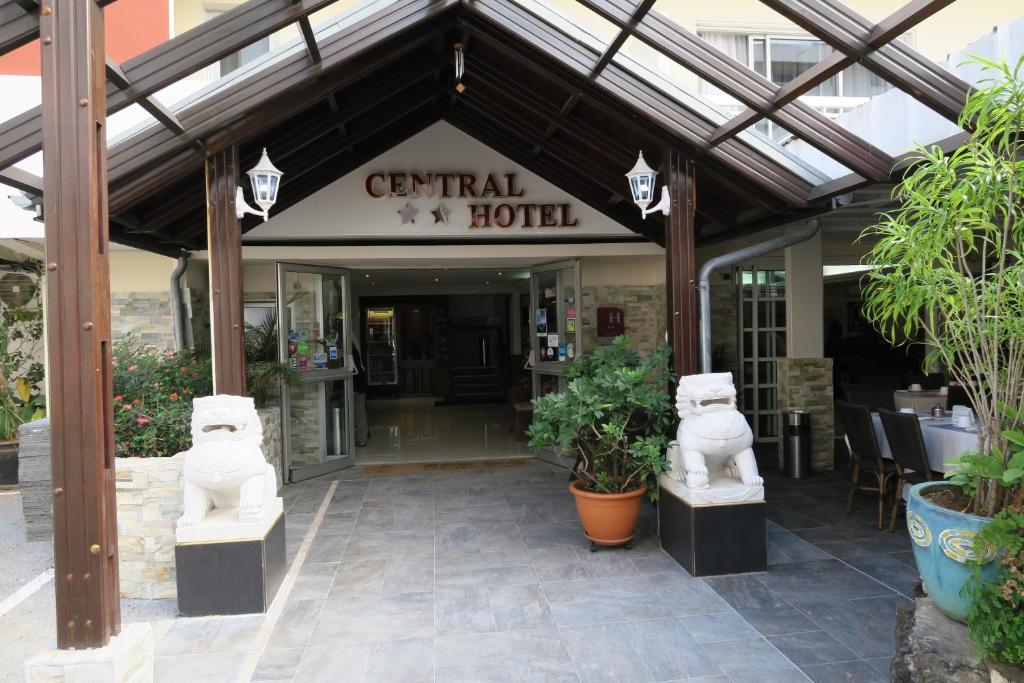 um hotel com duas estátuas em frente a um edifício em Central Hotel em Saint-Denis