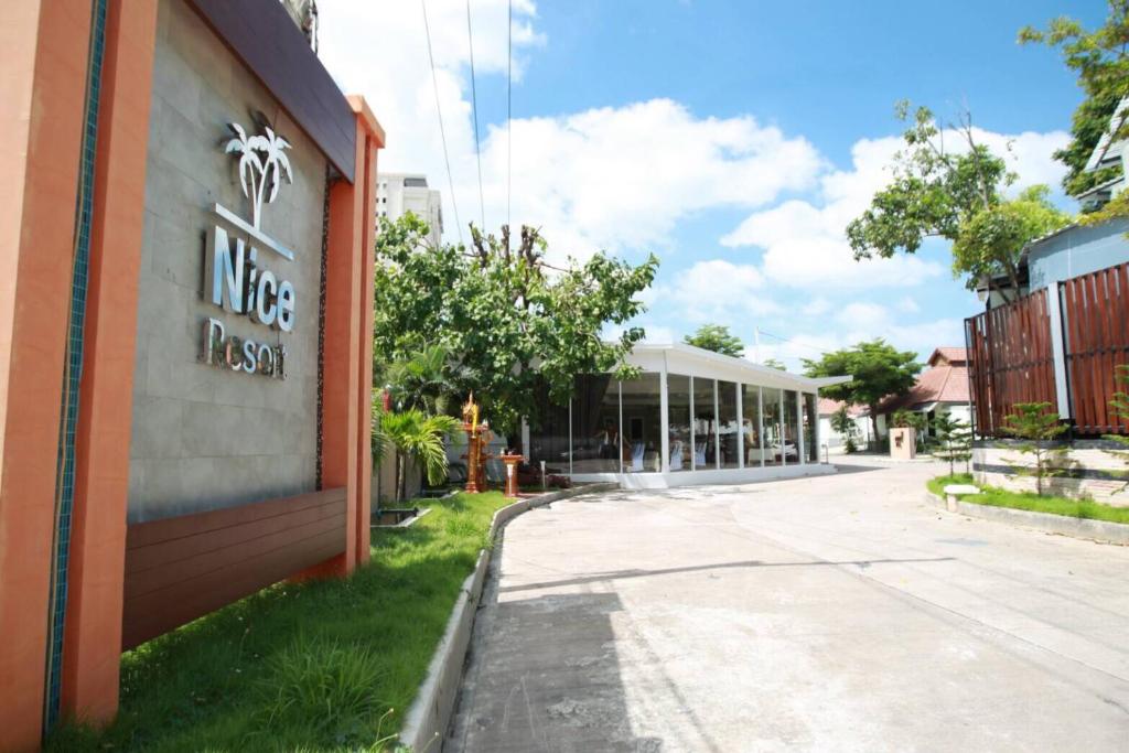 a building with a sign on the side of it at Nice Resort Pattaya in Pattaya