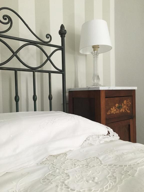 a close up of a bed with a lamp on a table at Oriani 20 in Bologna