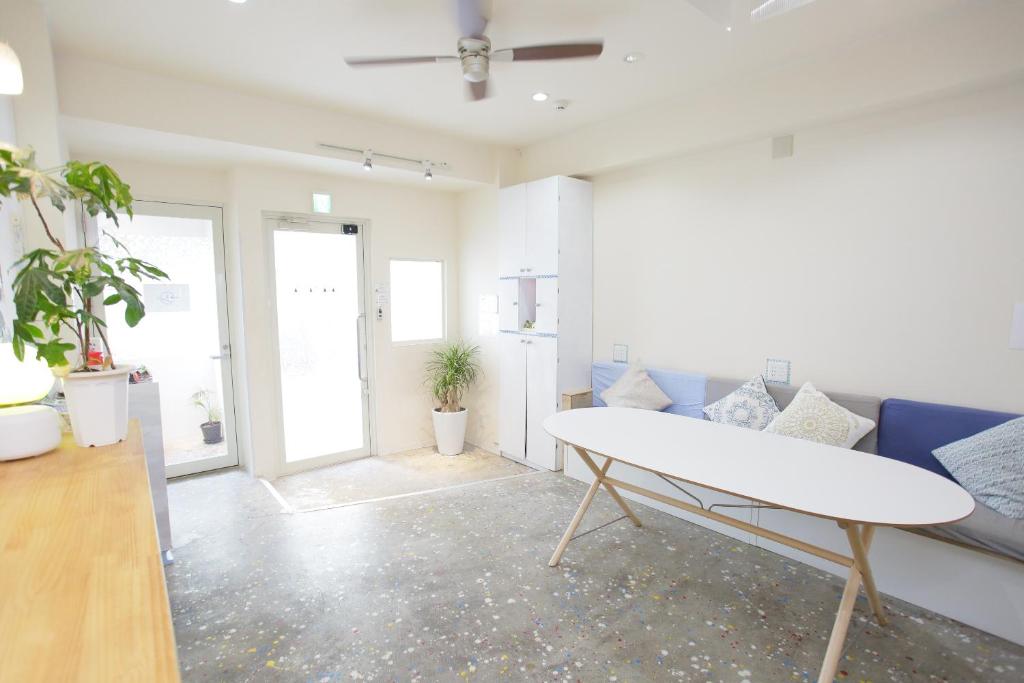 a living room with a couch and a table at Casa Blanca Guesthouse in Nagasaki