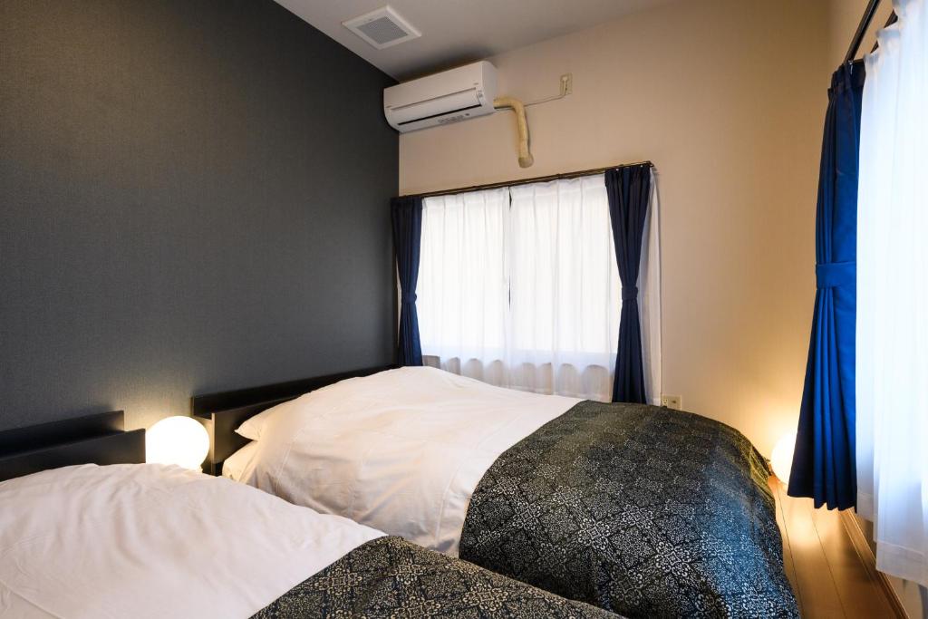 Postel nebo postele na pokoji v ubytování Ryokan Ichinao