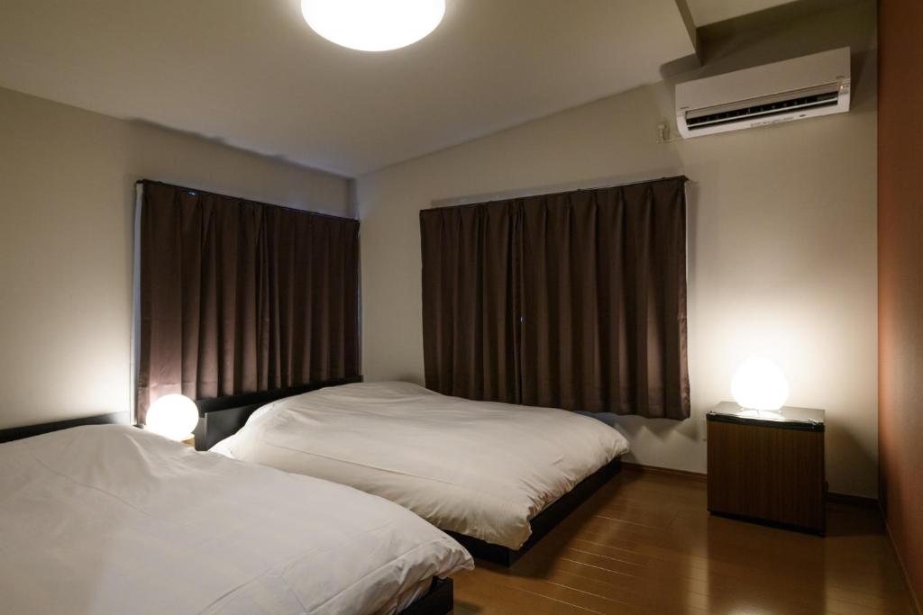 Postel nebo postele na pokoji v ubytování Ryokan Ichinao