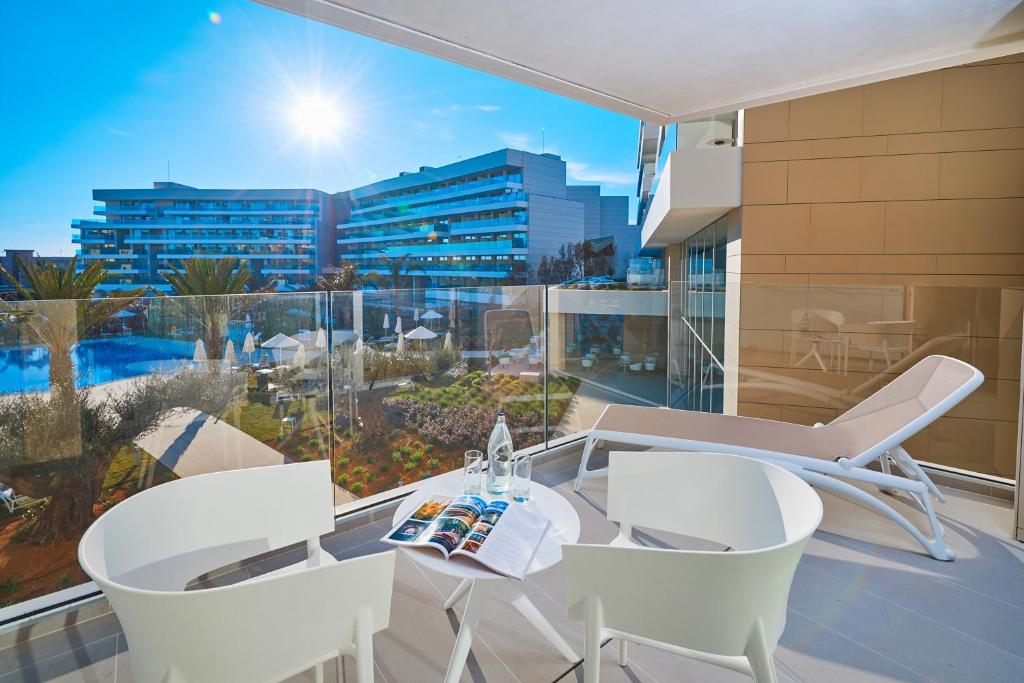 a balcony with a table and chairs and a view of the city at Hipotels Playa de Palma Palace&Spa in Playa de Palma
