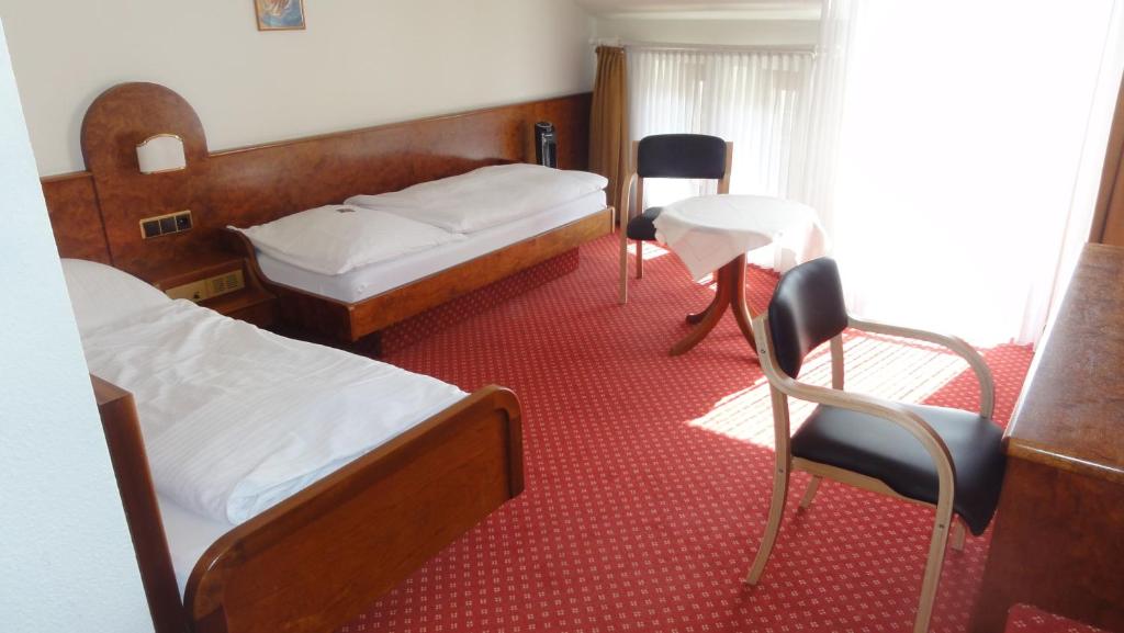 Postel nebo postele na pokoji v ubytování Hotel Post Viernheim