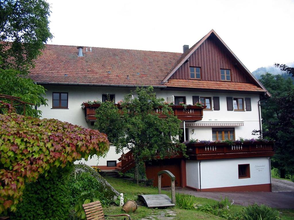 a large white house with flower boxes on it at Schnurrenhof in Seebach