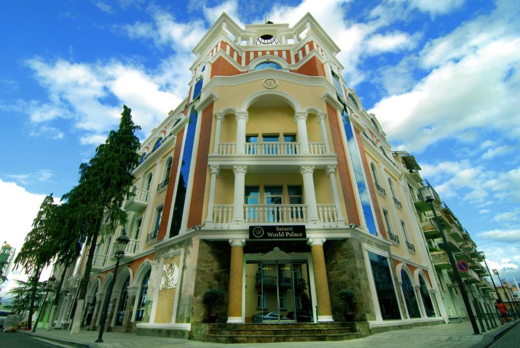 a large building on the corner of a street at Batumi World Palace in Batumi