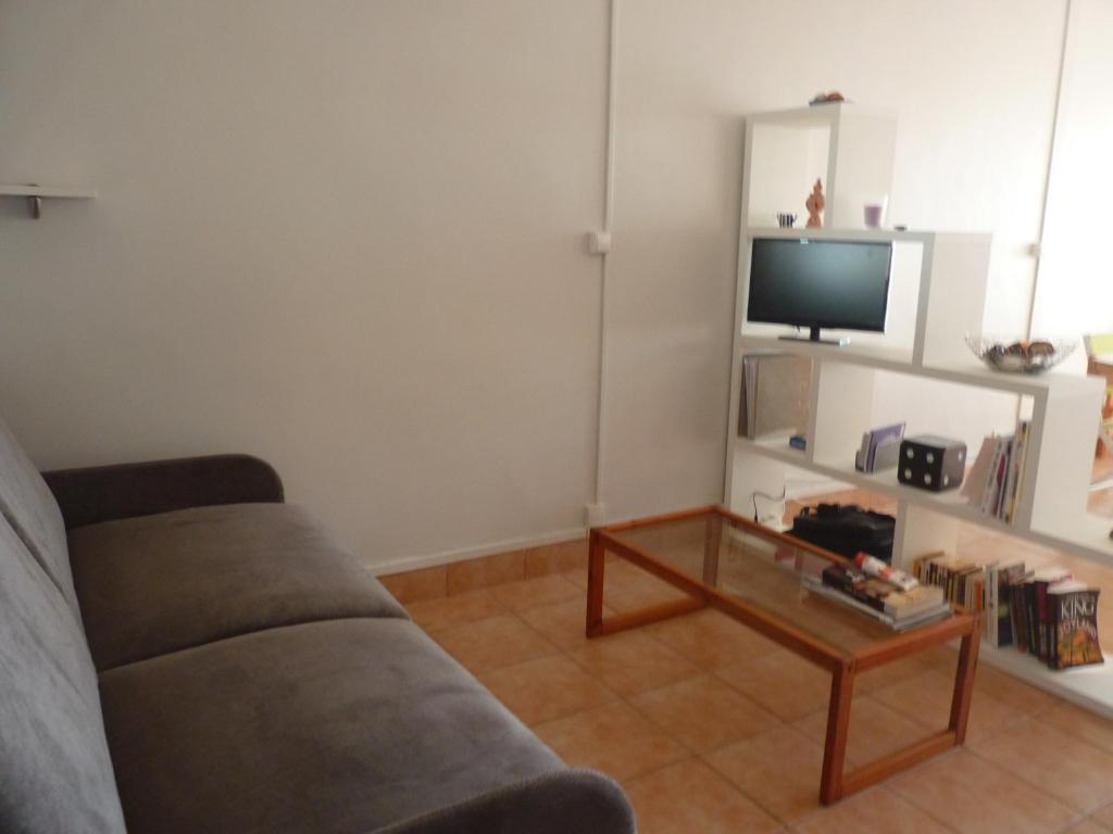 a living room with a couch and a coffee table at Appartement T2 RDC, Front de Mer, 4 couchages, Les Balcons de la Méditerranée Narbonne Plage in Narbonne-Plage