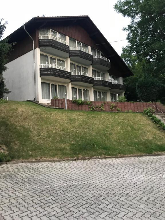 a house on a hill with a brick driveway at Penz in Wolfshagen in Langelsheim