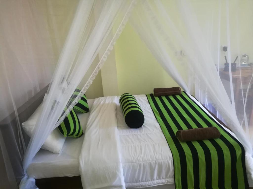 Postel nebo postele na pokoji v ubytování Dinaro Guest