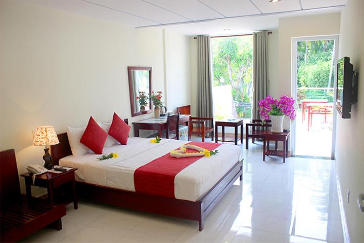 Giường trong phòng chung tại Ha Anh Hotel - Mui Ne