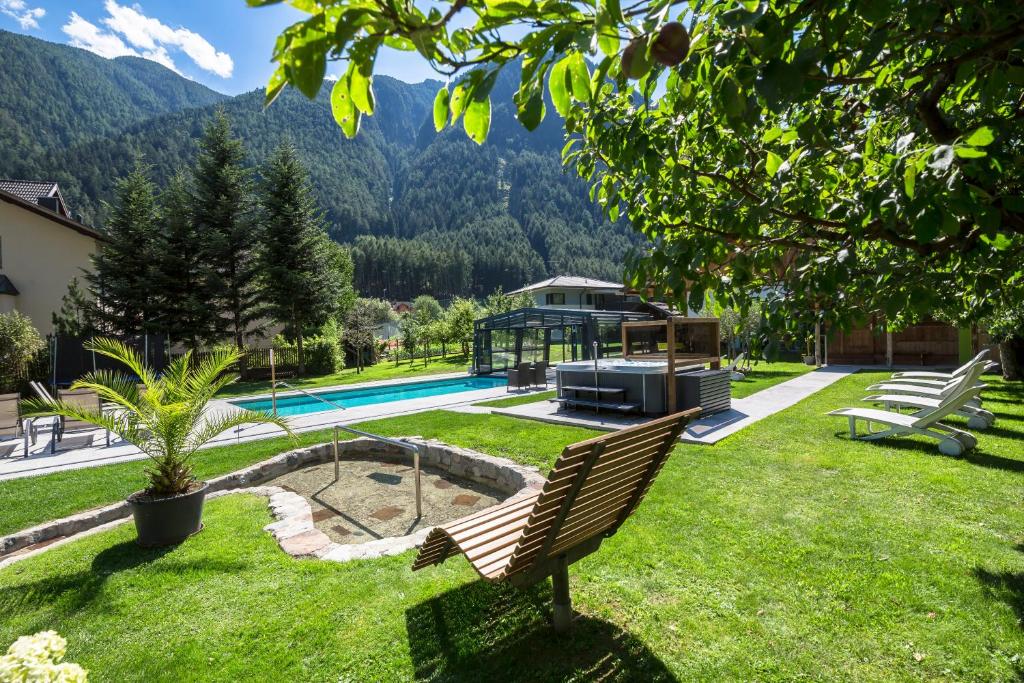 un cortile con panchina e piscina di Zur Brücke apartments and rooms - Your home in heart of South Tyrol, with Brixencard a Fortezza