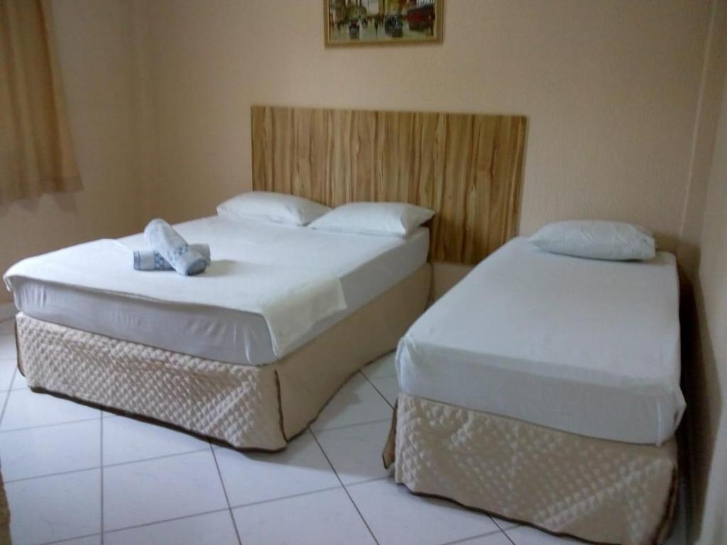 Säng eller sängar i ett rum på Pousada La Naila