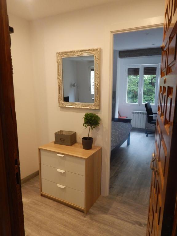 a living room with a dresser and a mirror at San Jose Blue in Zumaia