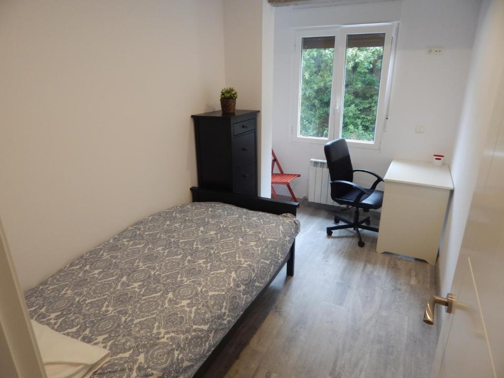 A bed or beds in a room at San Jose Blue