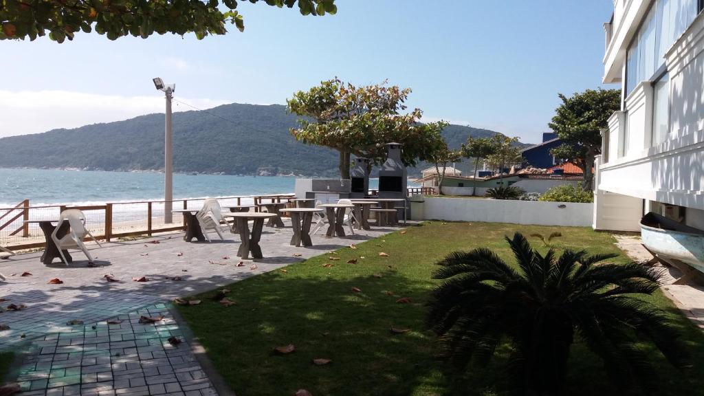 un parque con una mesa de picnic junto al agua en Residencial Villa do Mar, en Florianópolis