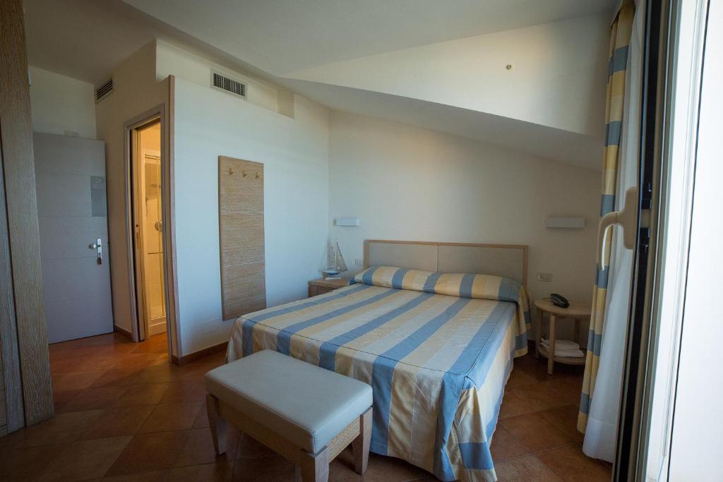 Postel nebo postele na pokoji v ubytování Hotel Miramare