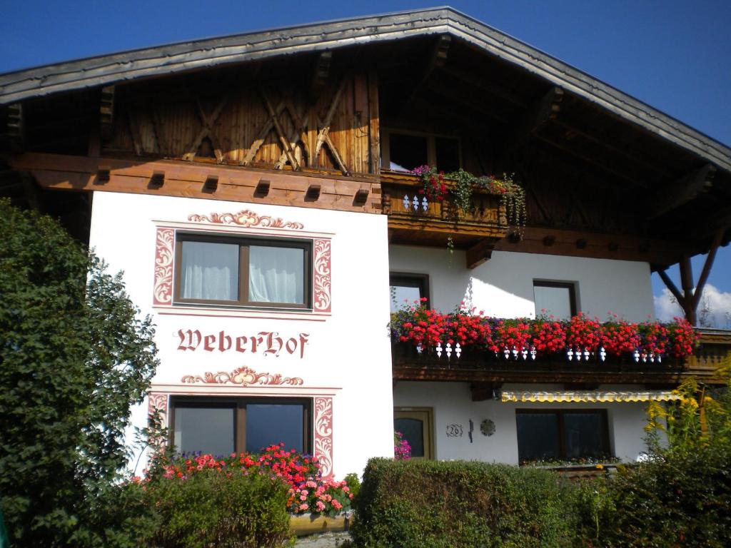 a white building with flowers on the balconies at Weberhof in Trins