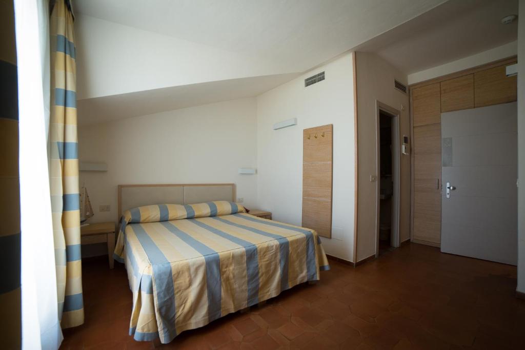 Postel nebo postele na pokoji v ubytování Hotel Miramare